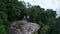 Aerial view of couple on the edge of the rock on the mountain view point