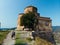 Aerial view of couple tourists at Jvari clifftop orthodox monastery located in Mtskheta Georgia. Summer day time. Travel and