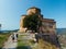 Aerial view of couple tourists at Jvari clifftop orthodox monastery located in Mtskheta Georgia. Summer day time. Travel and