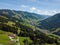 Aerial view on cozy hut with mountain panorama from Hinterglemm to Saalbach in the Alps in Austria. on a sunny summer