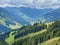 Aerial view on cozy hut with mountain panorama from Saalbach to Hinterglemm in the Alps in Austria on a sunny summer day