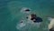 Aerial view of crashing waves on rocks