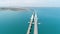 Aerial view of the crimean Bridge across the Kerch Strait. Shot. Amazing long bending bridge above calm turquoise sea.