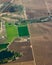 Aerial view of cropland with green pasture