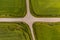 aerial view of a crossroads on country gravel no traffic road among fields