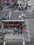 Aerial view of crowd of people crossing street to get to ballpark as MUNI train and cars move along King street