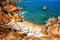 Aerial view of crowded Camilo beach in Lagos, Algrave, Portugal during the sunny day