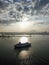 Aerial view cruise ship move at container terminal during sunrise.