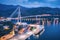 Aerial view of cruise ship in port and beautiful bridge at night