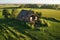 aerial view of a crumbling barn in a field