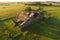 aerial view of a crumbling barn in a field