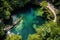 aerial view of a crystal clear natural pool surrounded by lush greenery