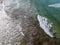 Aerial view of a crystal clear sea with waves and surfers. Playa De La Canteria. Orzola, Lanzarote, Canary Islands. Spain