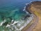 Aerial view of a crystal clear sea with waves and surfers. Playa De La Canteria. Orzola, Lanzarote, Canary Islands. Spain