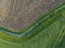 Aerial view of cultivated agricultural field with stream