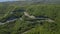 Aerial view of a curved winding road with cars passing