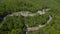 Aerial view of a curved winding road trough the mountains