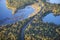 Aerial view of curving road between lakes and trees in autumn color in northern Minnesota