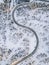 Aerial view of Curvy Windy Road in snow covered forest in Winter Finland