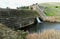 Aerial view of a dam in a vast countryside on a sunny day