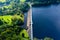 Aerial view of a dam wall and huge reservoir in a rural setting