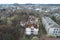 Aerial view on damaged red single house roof after strong wind or explosion. Hole in the rooftop and floor.