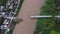 Aerial view of a damaged road bridge over a river after floodwaters washed away the asphalt. Broken bridge after flash floods in