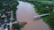 Aerial view of a damaged road bridge over a river after floodwaters washed away the asphalt. Broken bridge after flash floods in