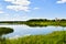 Aerial view Dambos lake pond panorama with St. Jacob the apostle church in Kurtuvenai town, with Lithuania countryside panorama