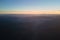 Aerial view of dark mountain hills at sunset. Hazy peaks and misty valleys in evening