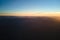 Aerial view of dark mountain hills at sunset. Hazy peaks and misty valleys in evening