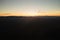 Aerial view of dark mountain hills at sunset. Hazy peaks and misty valleys in evening