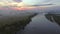 Aerial view of the dawn over the river in the fog