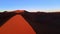 Aerial view of dazzling colourful dune in african desert. Magnificent contrast of natural landscape at sunset shot by