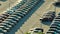 Aerial view of dealership parking lot with many brand new cars for sale. Development of american automotive industry