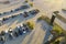 Aerial view of dealership parking lot with many brand new cars for sale. Development of american automotive industry