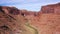 Aerial View Deep Gorge Canyon With Red Rocks Massive And Dry Riverbed In Desert