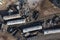 Aerial view of a demolition train a derailed train with several wagons lying on top of each other.