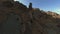 Aerial view desert mountain valley stone texture yellow dry trees plant blue sky empty landscape