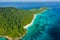 Aerial view of a deserted beach on a rugged tropical island surrounded by coral reef Koh Tachai