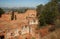 AERIAL VIEW OF THE DESOLATED ENTRANCE AND CRUMBLING INNER COURT OF AN OLD HISTORIC STONE FORT ON THE TOP OF A HIL