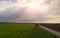 Aerial view, dirt road divides green and brown field