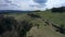 Aerial view of dirt road on grassland hills of central Slovakia mountains during spring season