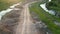 An aerial view of a dirt road near a river