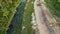 An aerial view of a dirt road near a river