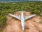 Aerial view of a discarded airplane on a private lot. The plots around the plane are for sale.