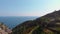 Aerial view from distance of Riomaggiore. Houses on the edge of the cliffs. bay with boats. plantation of grapes and olives. La Sp