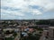 aerial view of a distant downtown neighborhood with beautiful clouds and trees