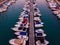 Aerial view of the docs with many yachts docked next to each other.