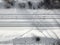 Aerial view of a double-track railway after heavy snowfall. Winter rail road with white snow, top view